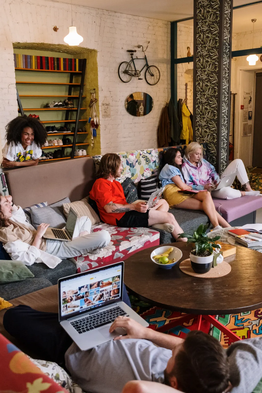 Housemates hanging out in a bright, cluttered lounge room